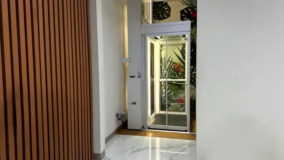 Two-Storey Home Lift Cost in Indonesia (2026) 6 Compact Ascenda home lift installed beside a staircase in a modern Indonesian home